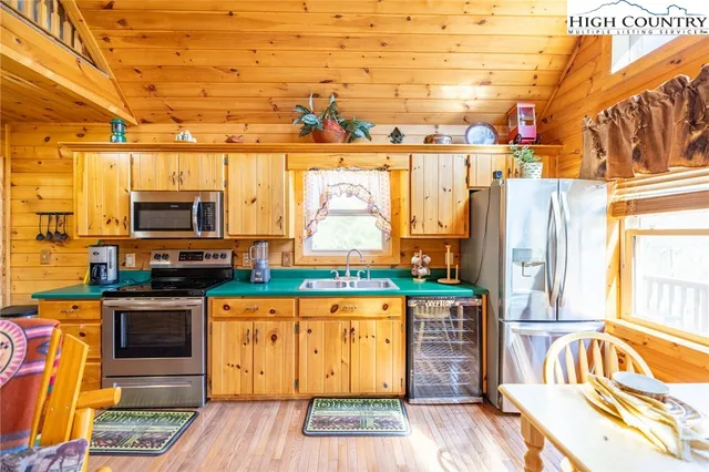 a kitchen with stainless steel appliances a stove and wooden cabinets