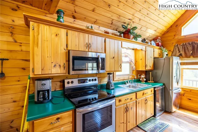 a kitchen with stainless steel appliances a stove and a microwave