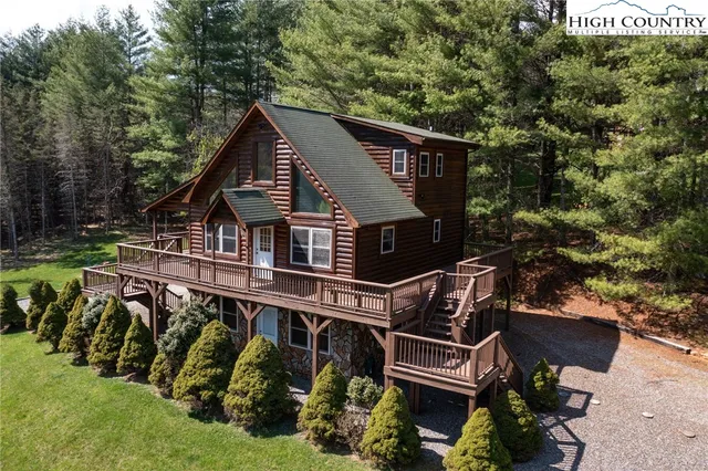 an aerial view of a house with a yard table and chairs