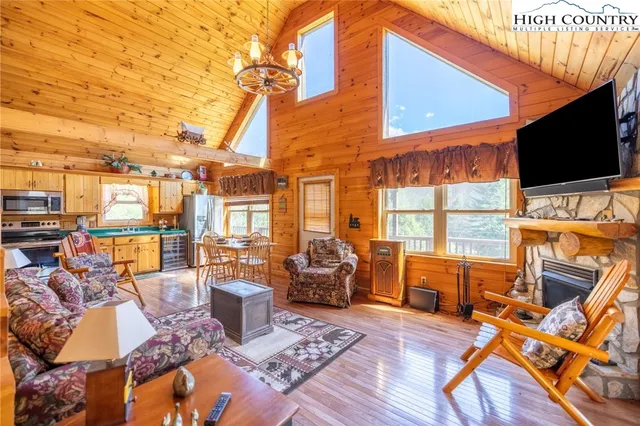 a view of a patio with couches chairs and wooden floor