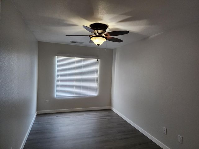 a view of workspace with wooden floor and a window