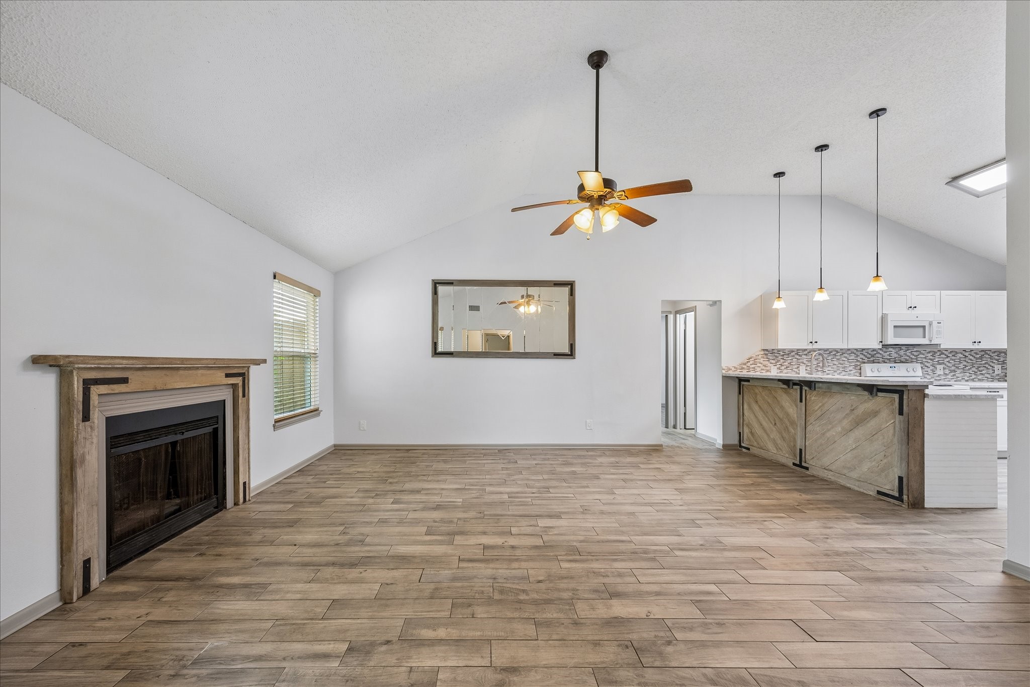 206 Lockett Street Brenham, TX 77833 - Photo 3 of 12 a view of a kitchen with a stove and a fireplace