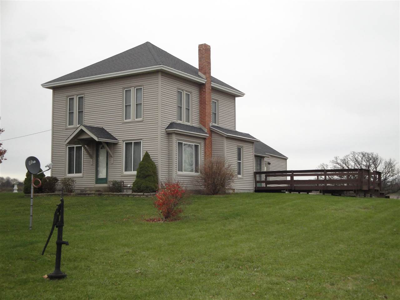 a view of a house with a yard and a patio