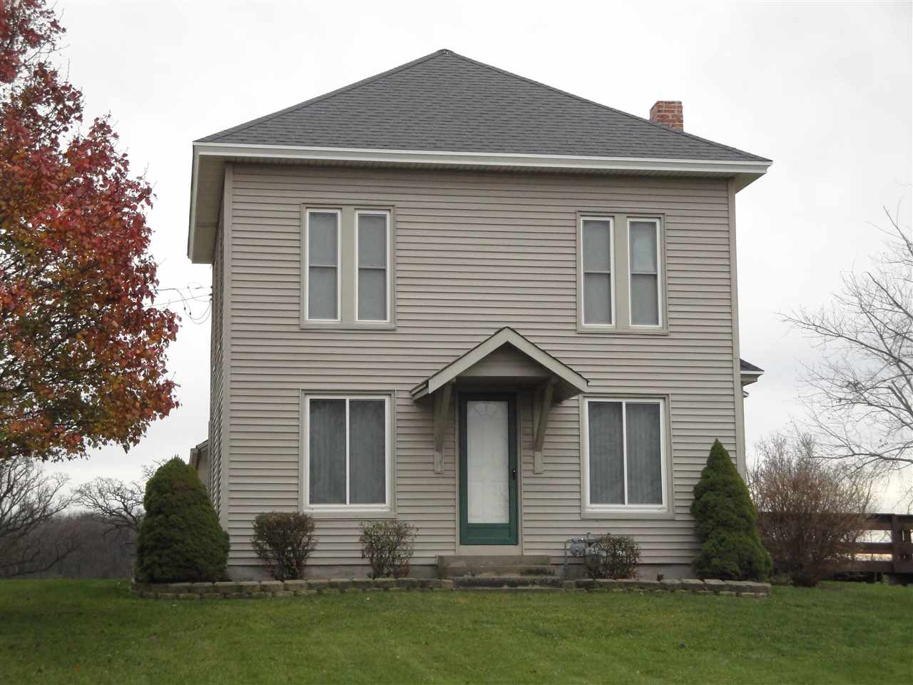 8005 Kishwaukee Road Stillman Valley, IL 61084 - Photo 2 of 12 a front view of a house with a yard and garage