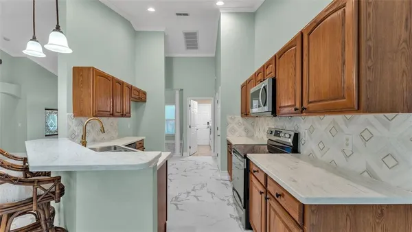 a kitchen with a sink a stove and cabinets