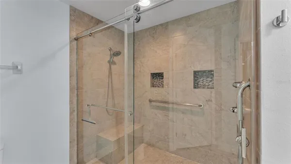 a bathroom with a granite countertop sink mirror vanity and toilet