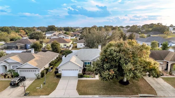 an aerial view of residential houses with outdoor space and street view