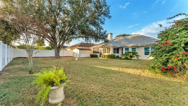 a view of house with a yard