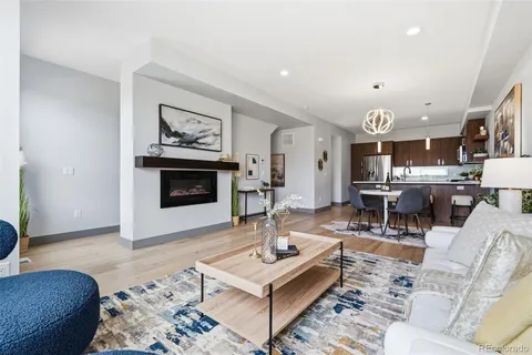 a living room with furniture a rug and a fireplace