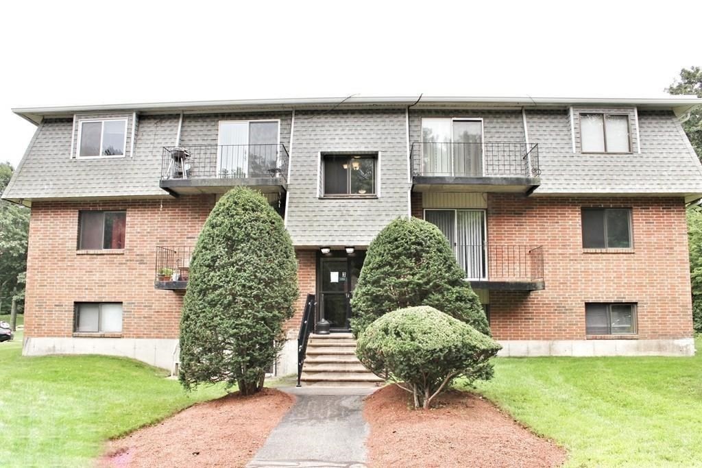 a front view of a house with a garden and plants