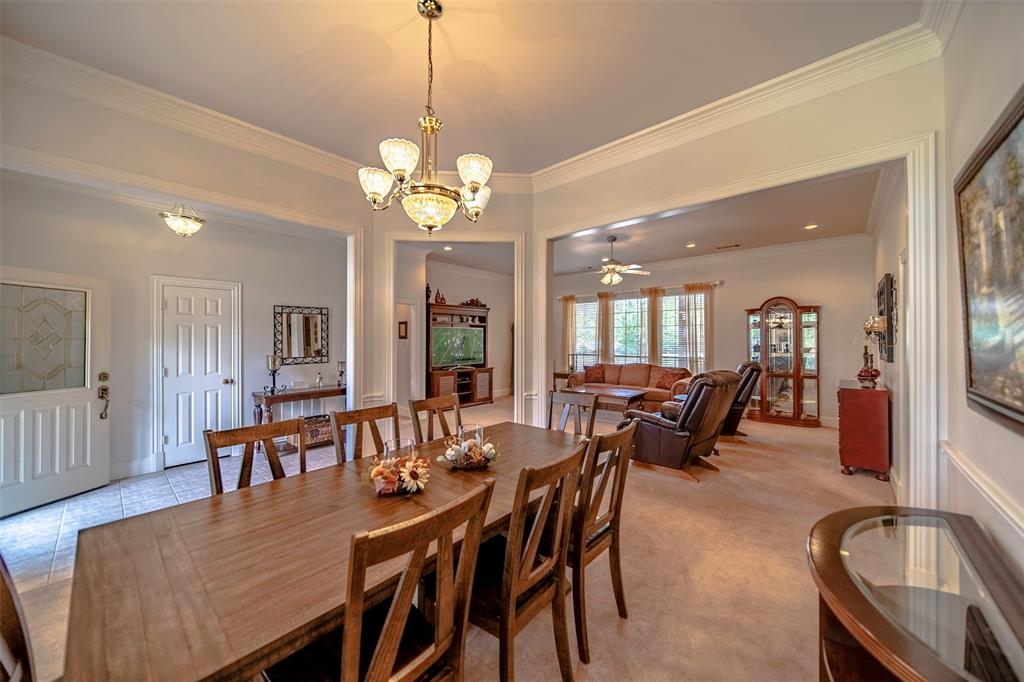 a view of a dining room and livingroom with furniture wooden floor a chandelier