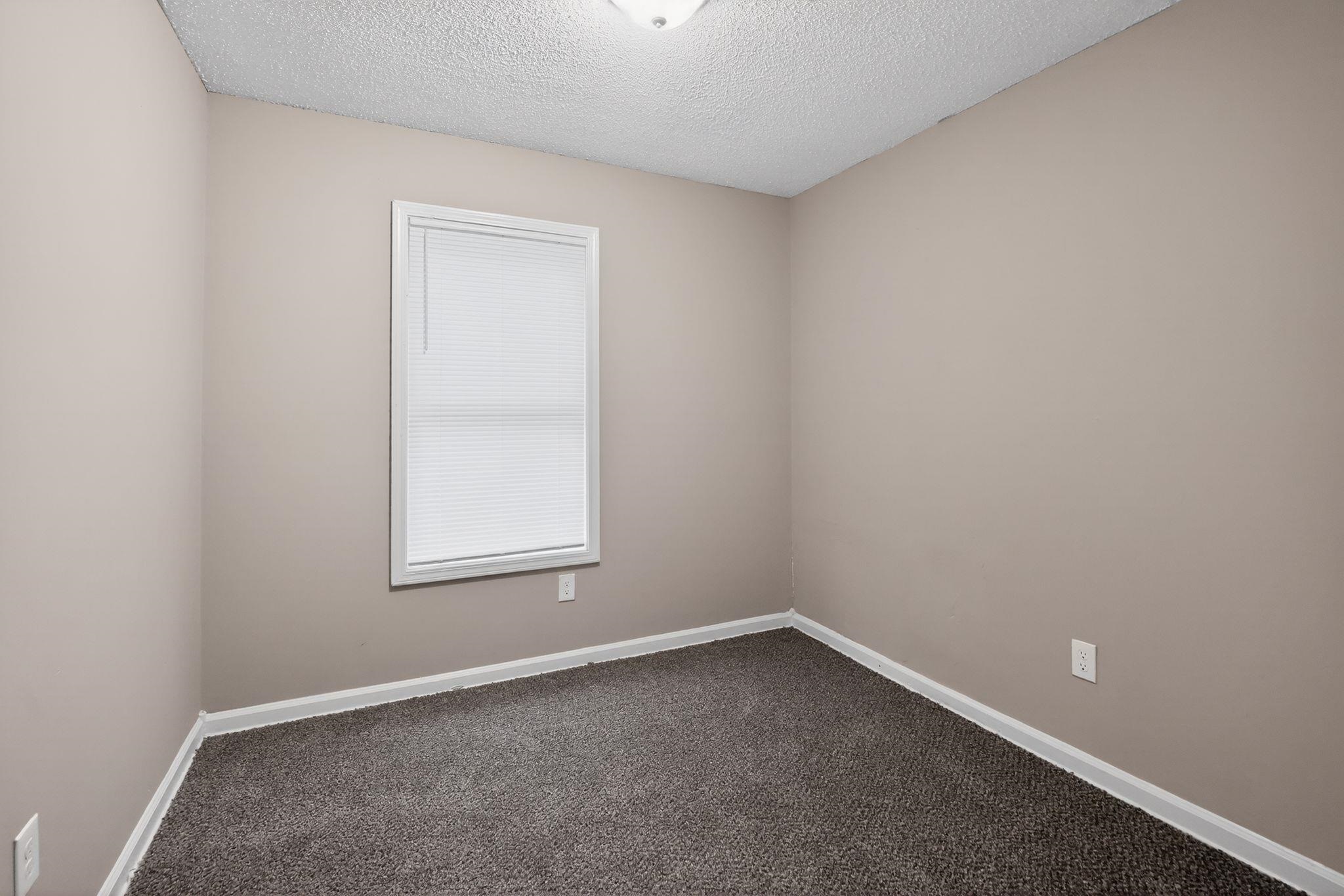 4725 Lofts Road Memphis, TN 38118 - Photo 12 of 32 Unfurnished room with dark carpet and a textured ceiling