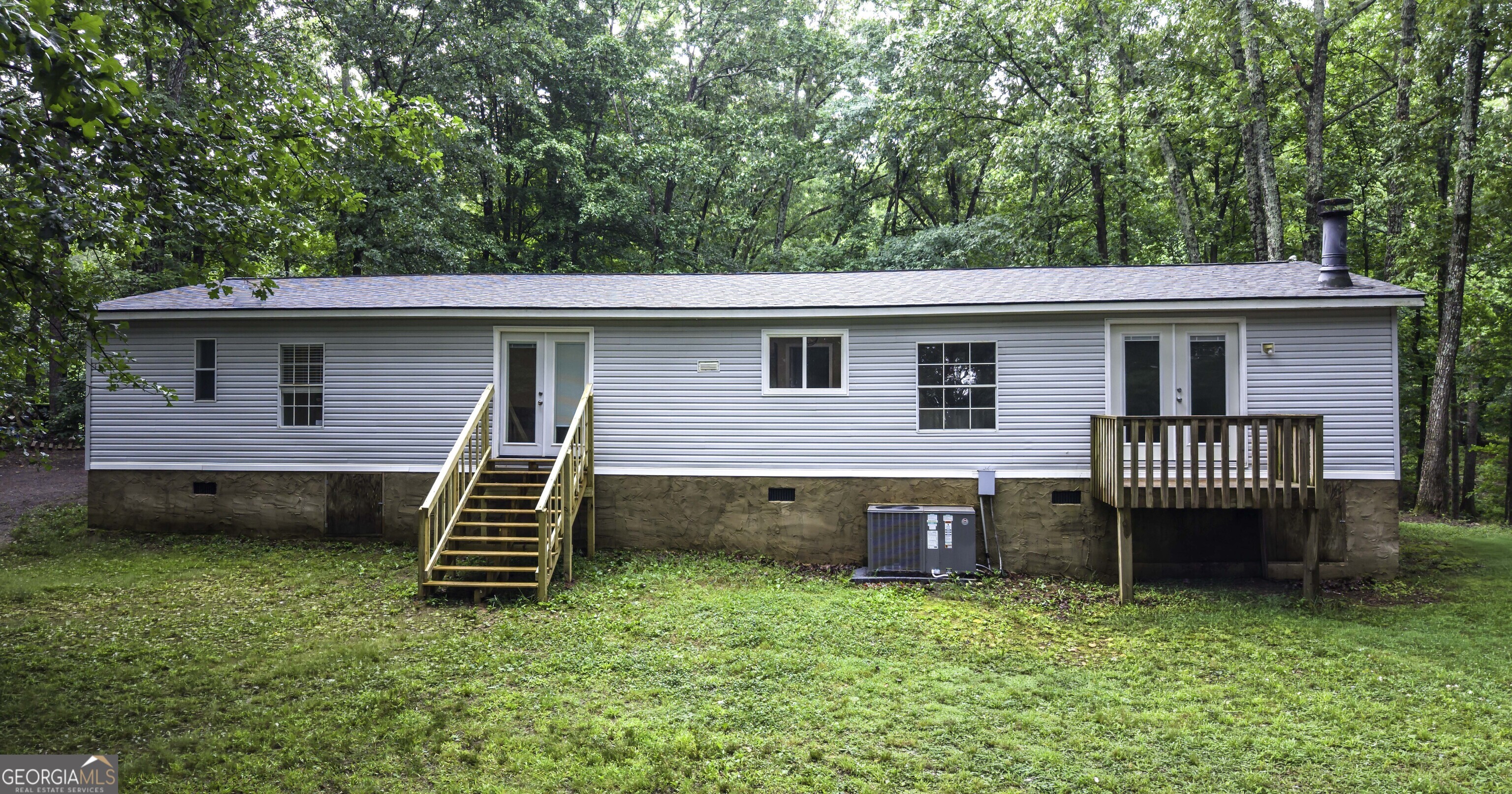 91 Holder Road Temple, GA 30179 - Photo 39 of 40 a front view of a house with a garden and deck