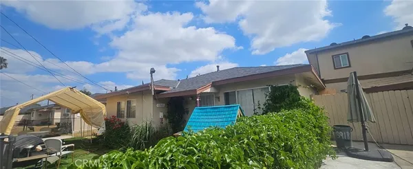 a view of house with backyard and garden