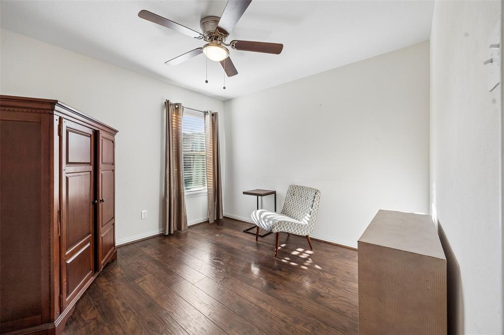 406 Madrone Lane Princeton, TX 75407 - Photo 17 of 30 Bedroom featuring wood-finish flooring, a window with blinds and drapes, and a ceiling fan with integrated lighting