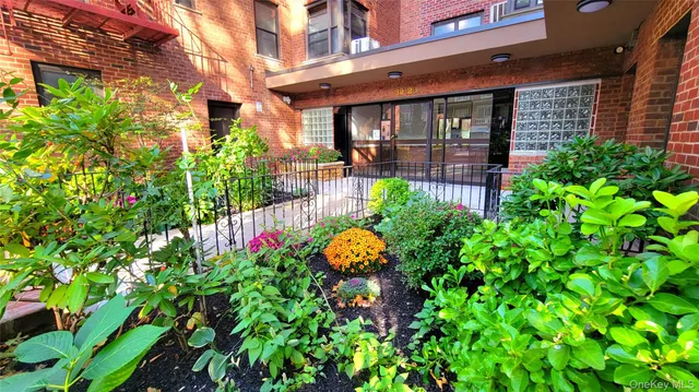 a flower plants in front of brick building