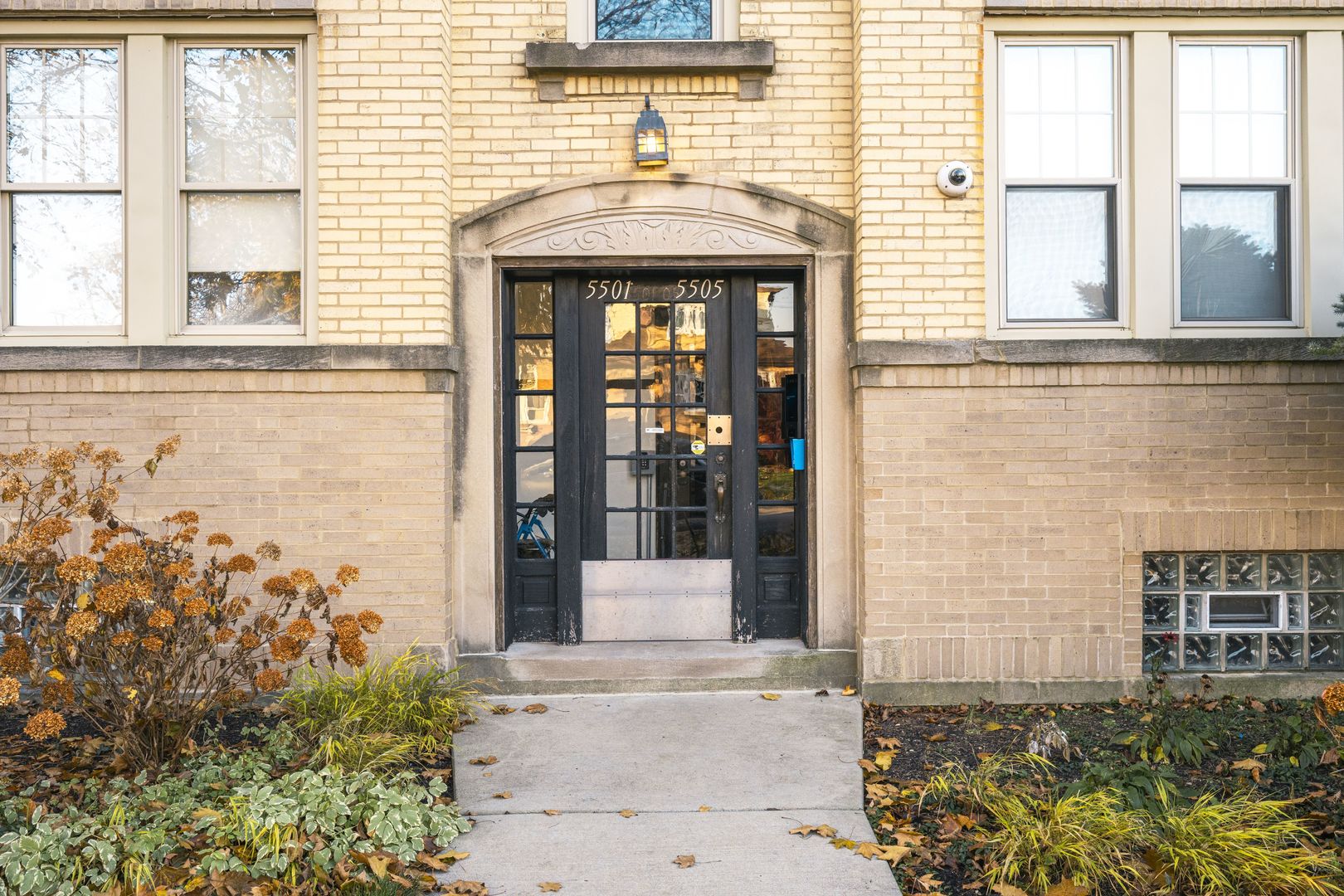 5501 West School Street, Unit 1C Chicago, IL 60641 - Photo 1 of 11 front view of a brick house with a large window