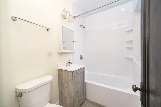 a bathroom with a shower a toilet and sink
