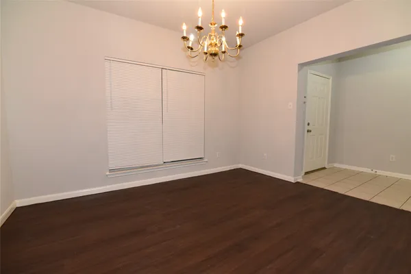 a view of a room with wooden floor