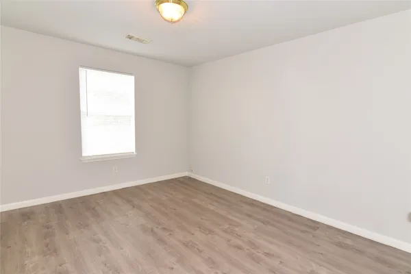 a view of a room with wooden floor and fan