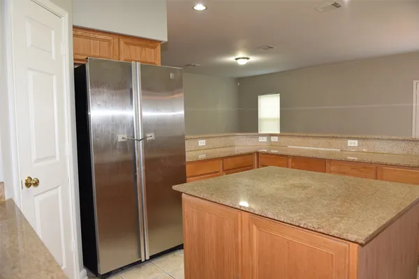 a bathroom with a granite countertop sink and mirror