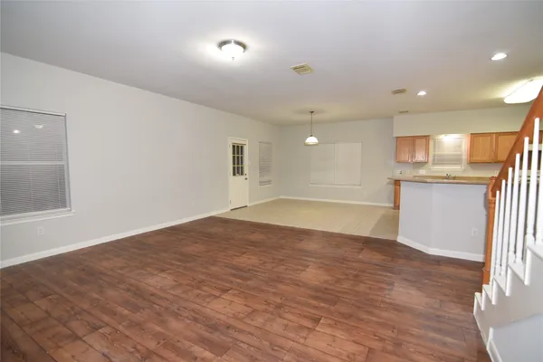 a view of a kitchen with a sink and a refrigerator