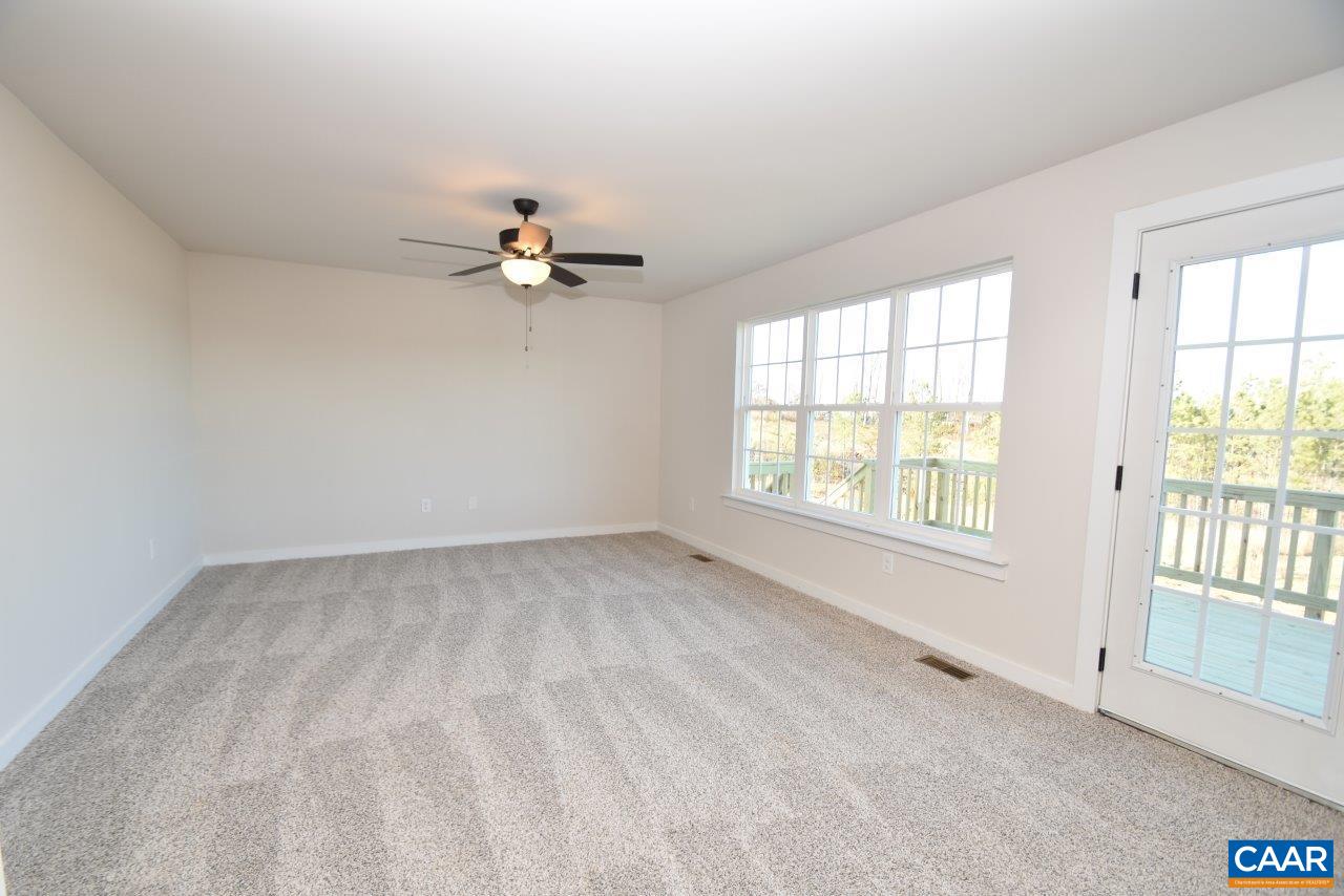 71 Riva Way Palmyra, VA 22963 - Photo 12 of 26 an empty room with chandelier fan and windows