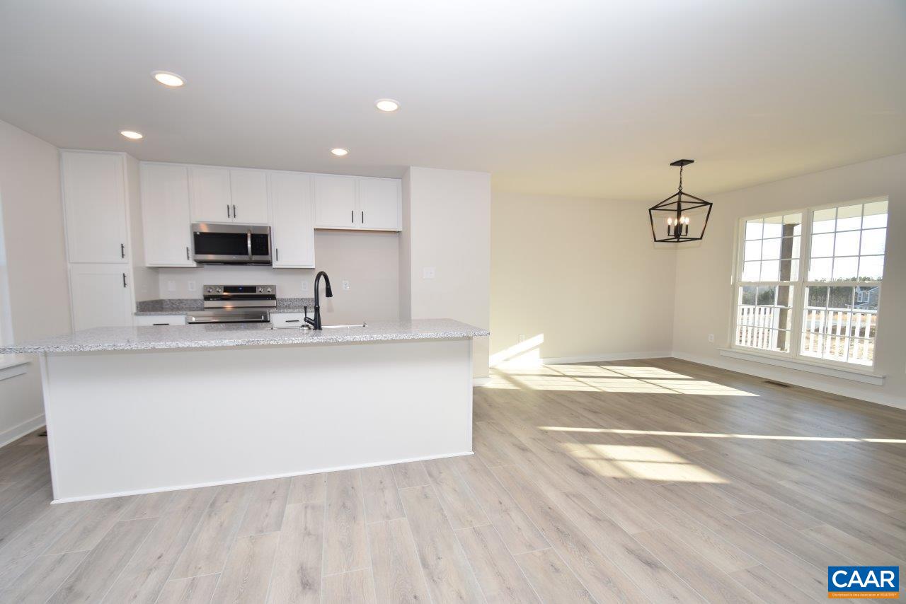 71 Riva Way Palmyra, VA 22963 - Photo 6 of 26 a kitchen with stainless steel appliances granite countertop a stove a sink and a microwave
