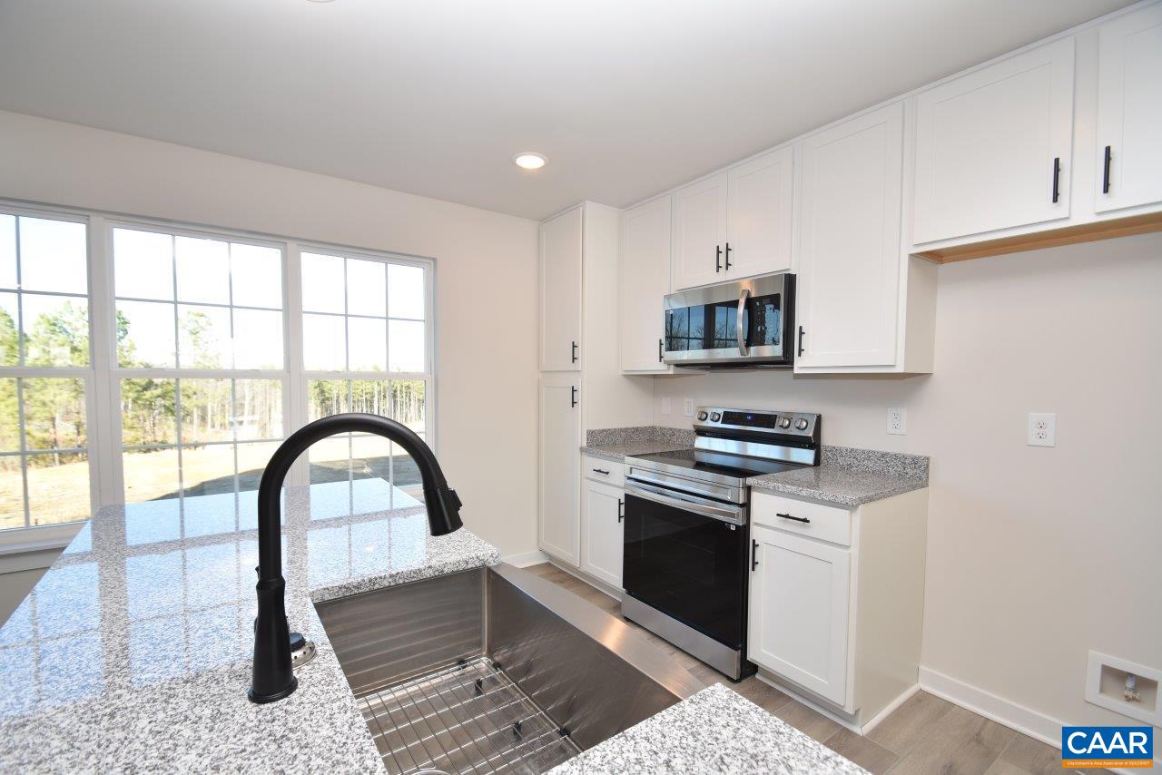 71 Riva Way Palmyra, VA 22963 - Photo 9 of 26 a kitchen with stainless steel appliances granite countertop a stove a sink and a microwave