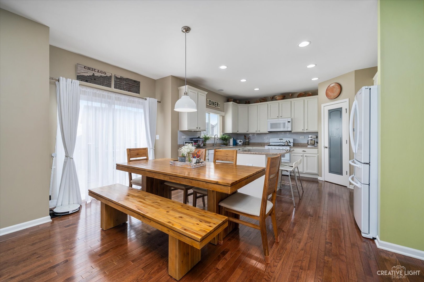 3521 English Prairie Road Elgin, IL 60124 - Photo 11 of 35 a kitchen with stainless steel appliances granite countertop a refrigerator a sink dishwasher a stove and white cabinets with wooden floor