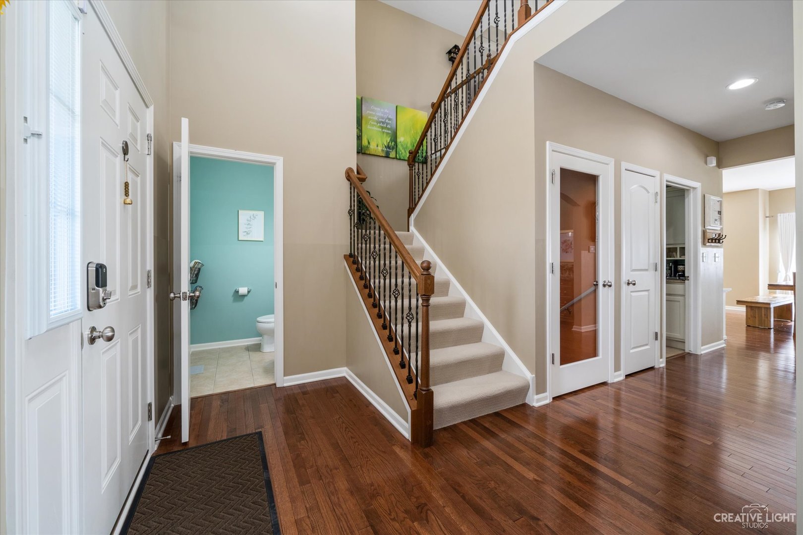 3521 English Prairie Road Elgin, IL 60124 - Photo 4 of 35 a view of a hallway with wooden floor and staircase