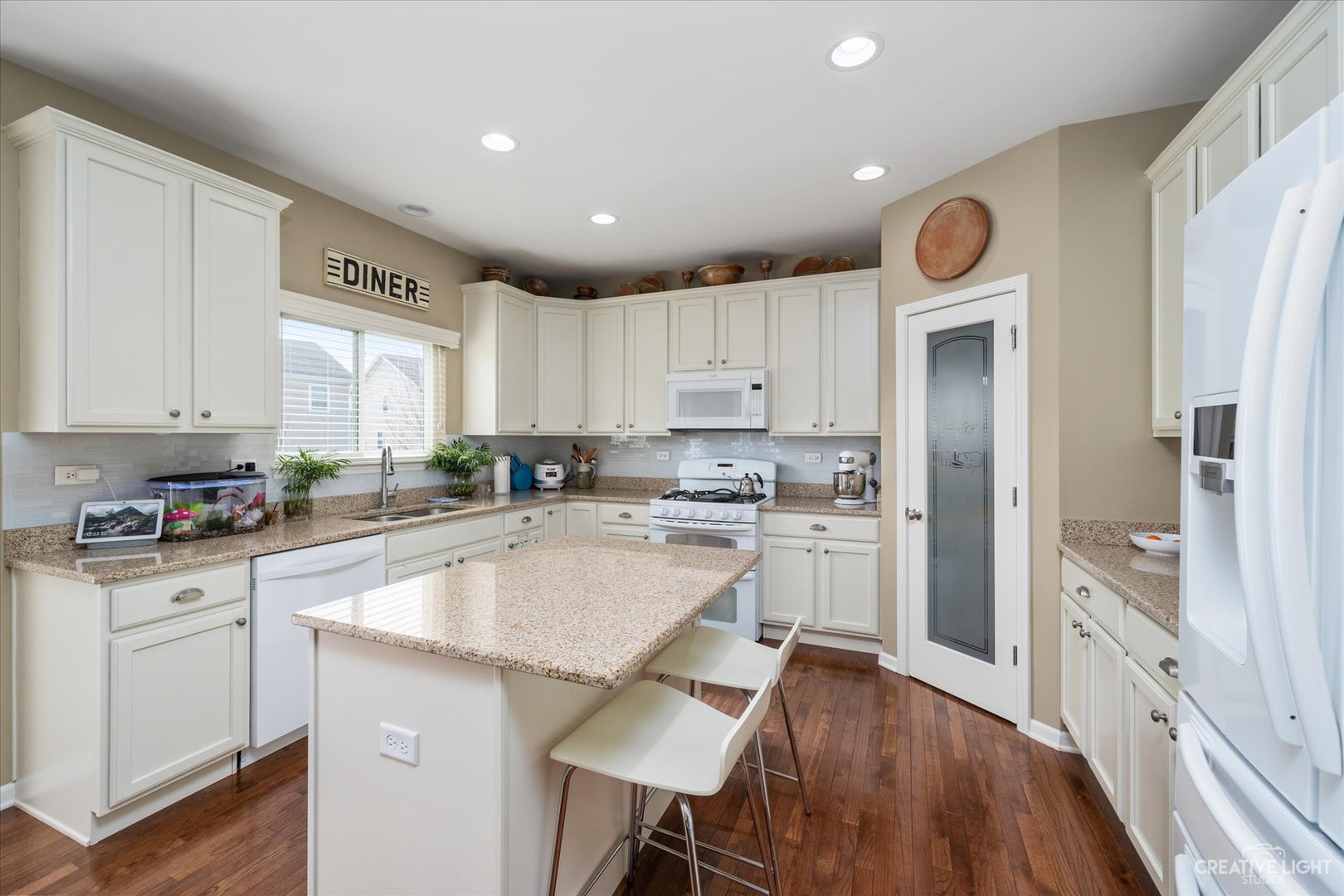 3521 English Prairie Road Elgin, IL 60124 - Photo 8 of 35 a kitchen with a sink a stove cabinets and wooden floor