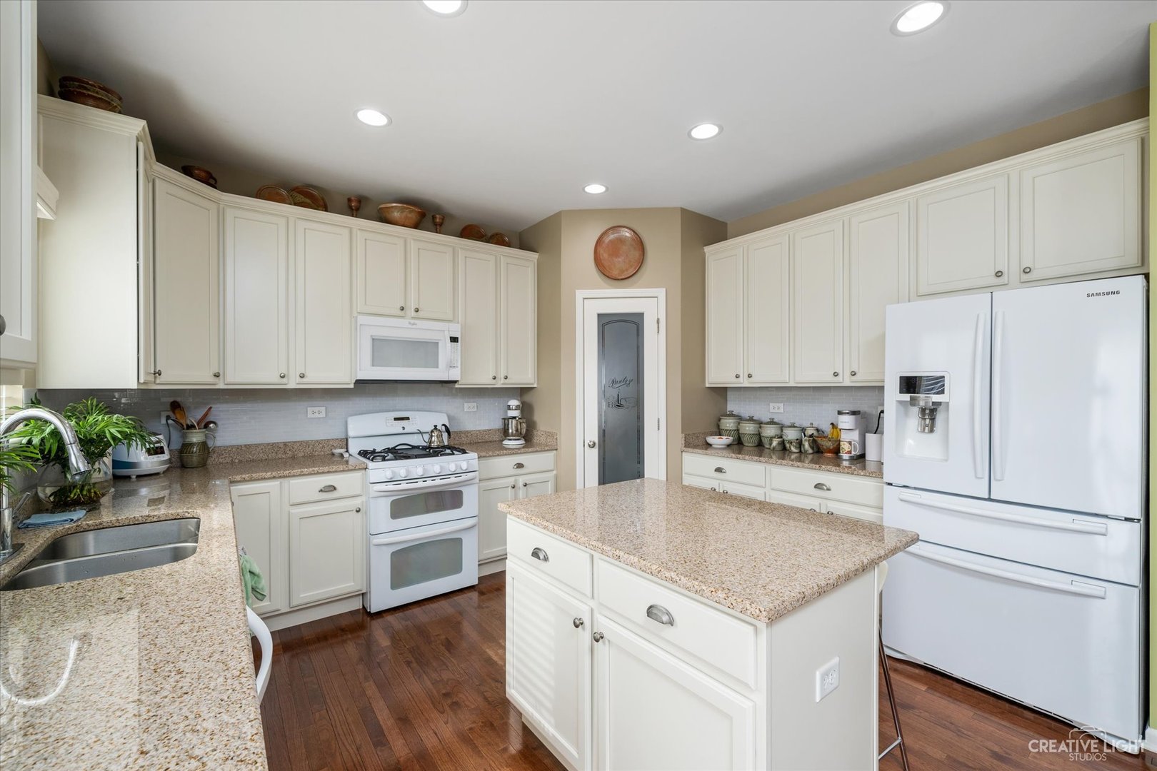 3521 English Prairie Road Elgin, IL 60124 - Photo 9 of 35 a kitchen with a refrigerator a stove a sink and white cabinets