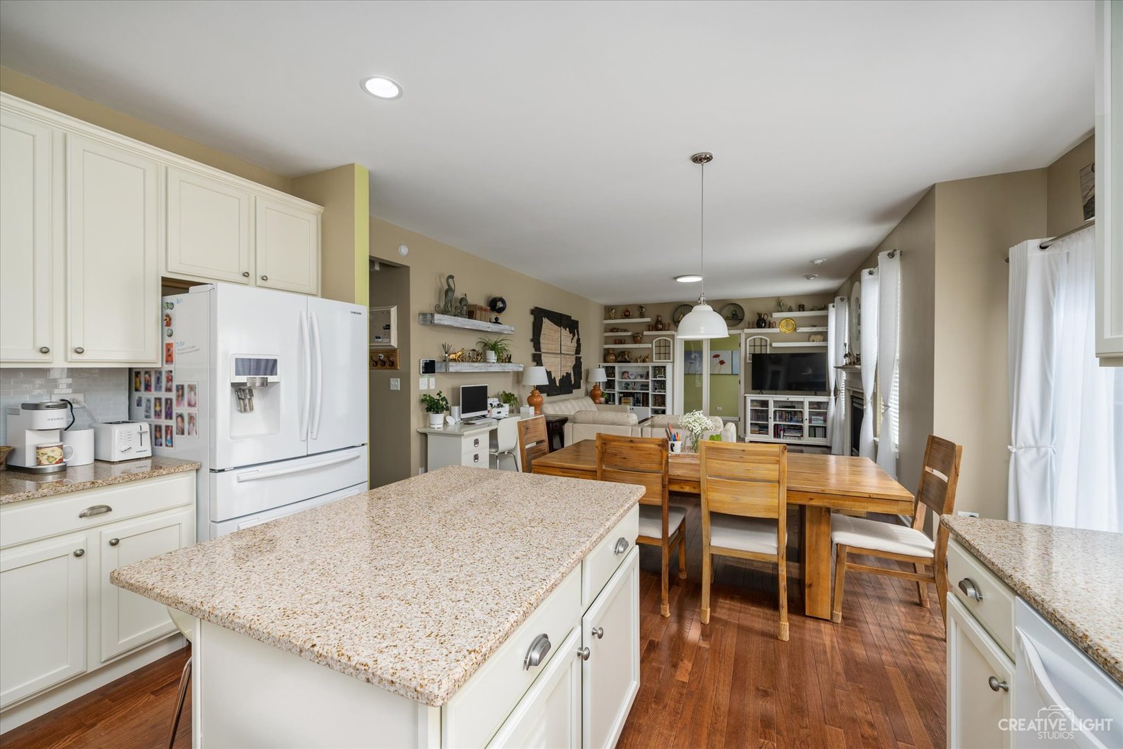 3521 English Prairie Road Elgin, IL 60124 - Photo 10 of 35 a kitchen with stainless steel appliances granite countertop a stove top oven a sink a dining table and chairs