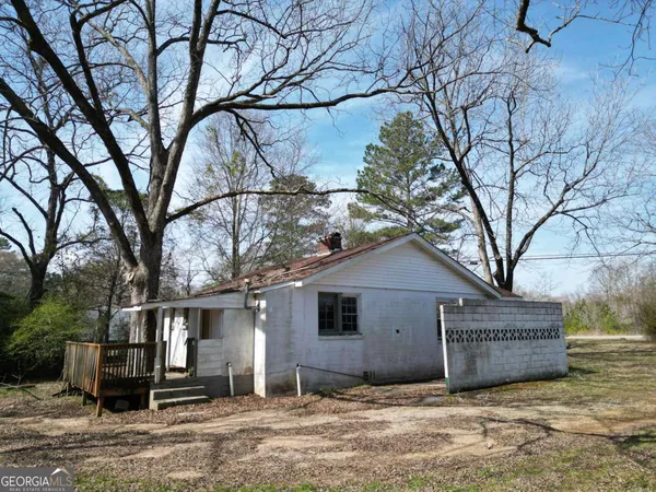 a view of a house with a yard covered in snow
