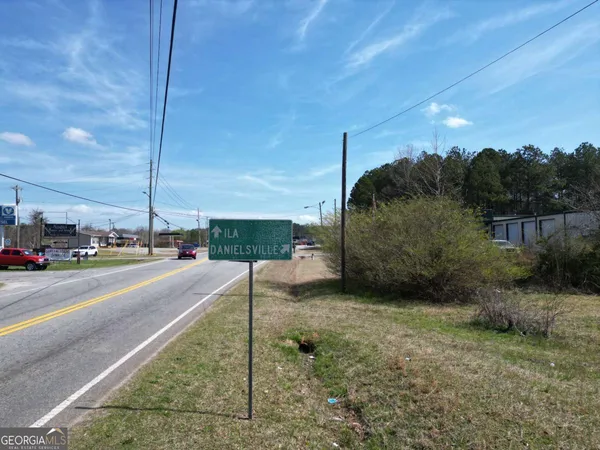 a view of a street with a car parked in front of it