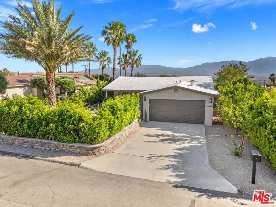 66869 San Ardo Road Desert Hot Springs, CA 92240 - Photo 39 of 39 a front view of a house with a yard and trees