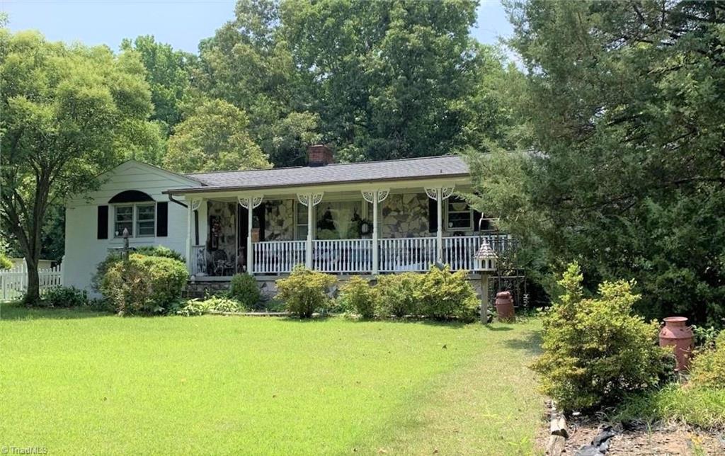 3208 Groometown Road Greensboro, NC 27407 - Photo 6 of 9 Large front yard with a rocking chair front porch.