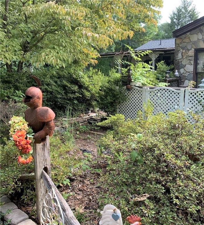 3208 Groometown Road Greensboro, NC 27407 - Photo 8 of 9 Several garden spaces around the house to work with.