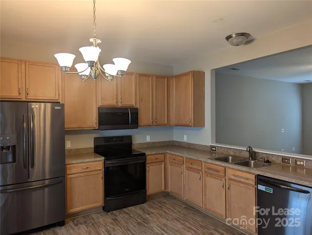 a kitchen with a refrigerator and a sink