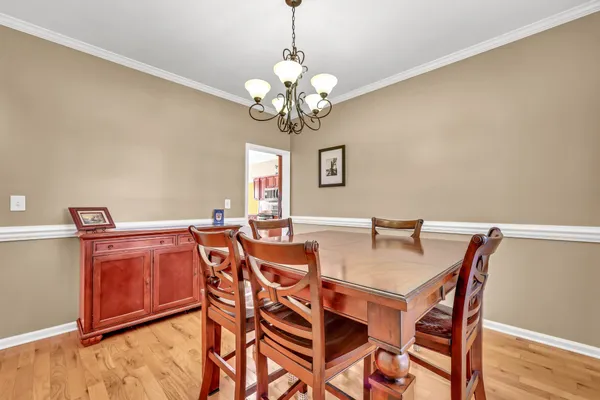 a view of a dining room with furniture and wooden floor