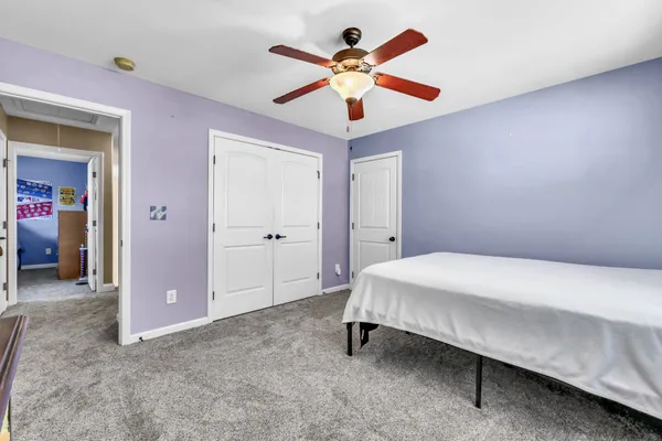 a bedroom with a bed and a chandelier