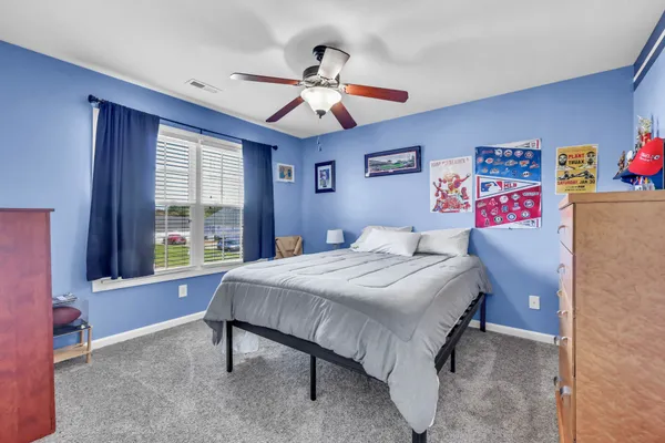 a bedroom with a bed and a chandelier