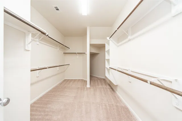a view of a big room with wooden floor and staircase