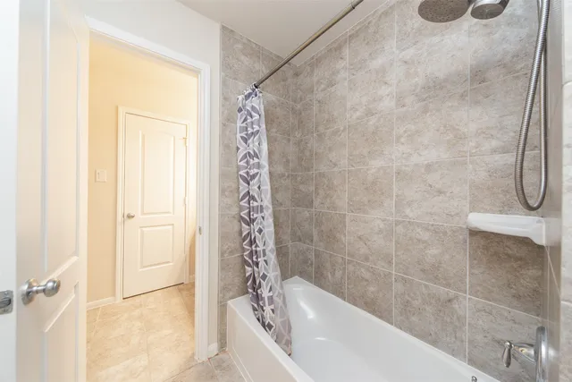 a bathroom with a bathtub and shower
