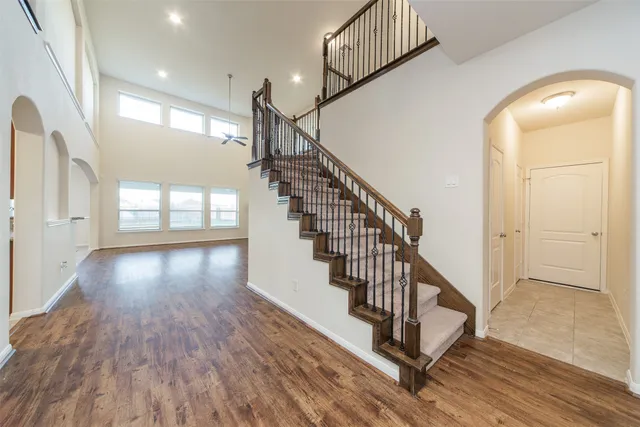 a view of entryway and hall with wooden floor