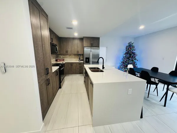 a bedroom with a bed lamp and a mirror