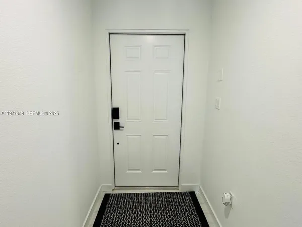 a bathroom with a sink mirror and toilet