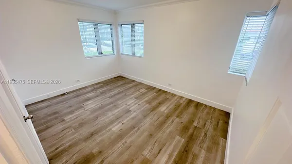 a view of wooden floor and windows in a room