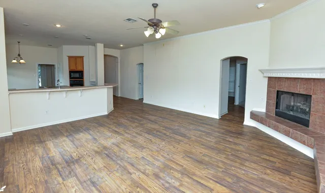 a view of kitchen with granite countertop cabinets and wooden floor